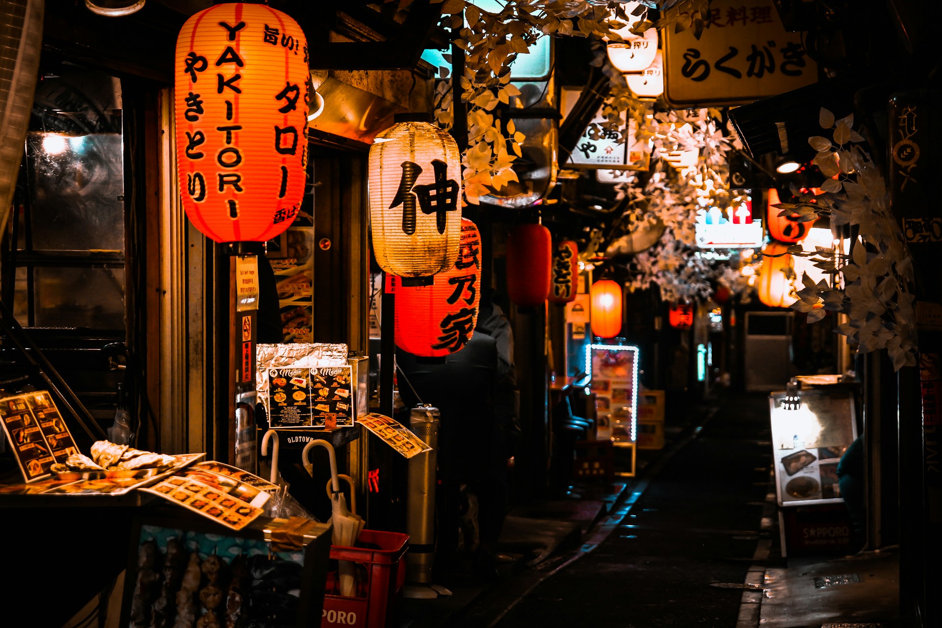 Entrance of a Japanese restaurant with a noren curtain and lantern
